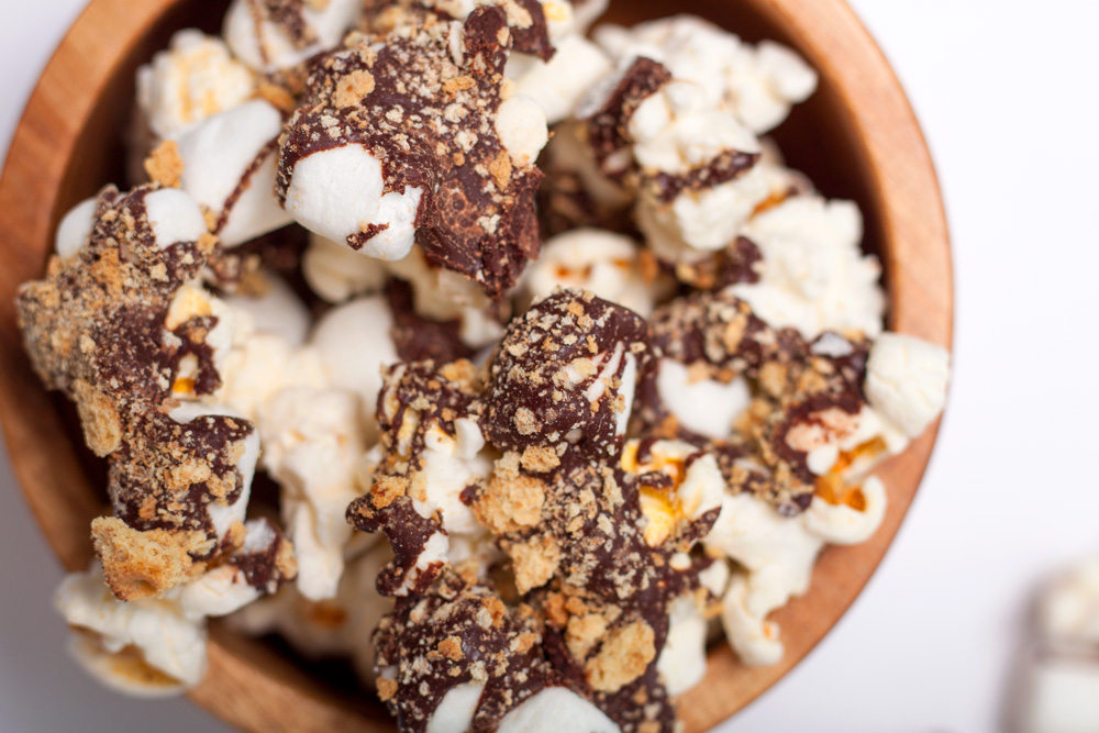 Chocolatey, marshmallowy, graham cracker dusted S'mores Popcorn. It's like being on a camping trip minus the actual camping and adding some popcorn!