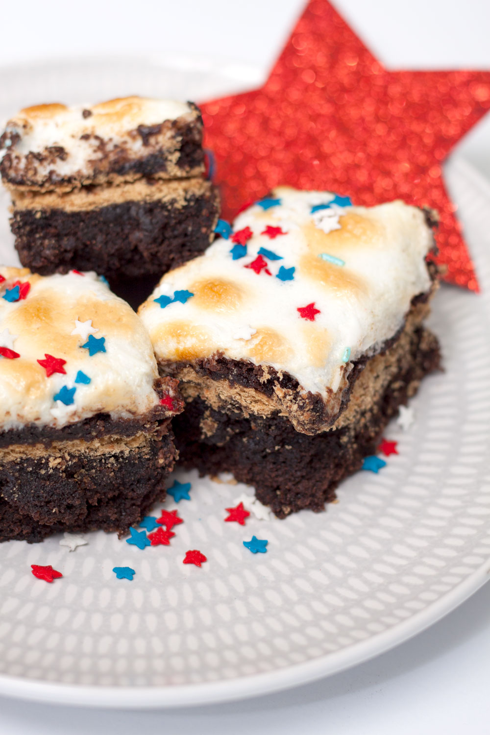 Marshmallow, brownie, graham crackers, chocolate chips, and sprinkles. S'mores Brownie Bars, just as messy as the original and twice as delicious. It's your new s'mores recipe.